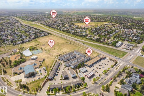 Aerial perspective showcasing the residential community, commercial spaces, and surrounding green areas - 47 330 Bulyea Road, Edmonton, AB - Outdoor With View