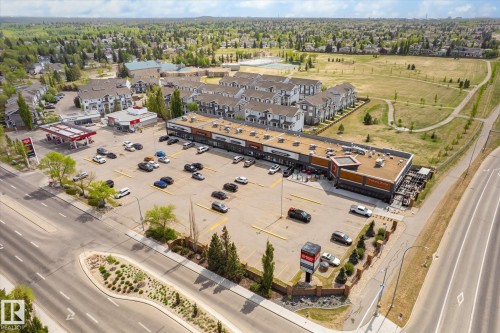 Commercial retail strip center with ample surface parking, multiple storefronts, and direct street access - 47 330 Bulyea Road, Edmonton, AB - Outdoor With View