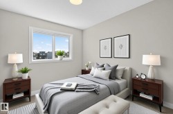 Bright bedroom featuring a large window, soft neutral wall tones, and carpet flooring - 