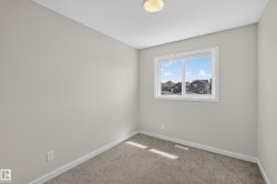 Light-filled room featuring neutral wall paint, white trim, and a window offering natural illumination - 