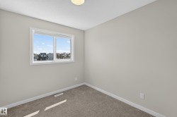 Neutral-toned walls complement the textured carpet flooring - 