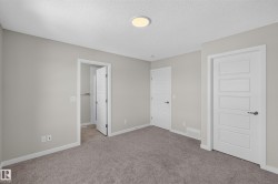 Neutral-toned room featuring plush grey carpeting and light grey walls - 