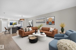 Open-concept living area featuring light wood-finish flooring, recessed lighting, and a contemporary pendant light fixture - 