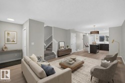 Open-concept living area featuring wood-finish flooring, recessed lighting, a modern kitchen island with seating, and a pendant light fixture - 