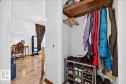 Interior closet with built-in wood shelving and hanging rod - 