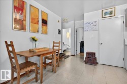 Light-colored flooring extends throughout this interior space with white walls - 
