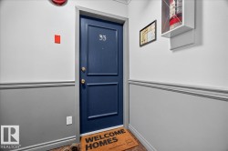 Navy blue paneled entry door with brass hardware and trim - 