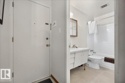 Full bathroom with light-colored flooring and white subway tile shower surround - 