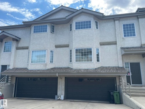 Stucco exterior with multiple bay windows and prominent white trim - 2 1295 Carter Crest Road, Edmonton, AB - Outdoor