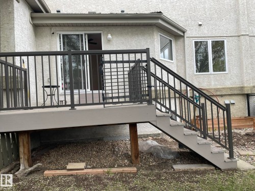 Exterior deck with gray composite decking and matching stairs, featuring dark metal railings - 2 1295 Carter Crest Road, Edmonton, AB - Outdoor With Deck Patio Veranda With Exterior