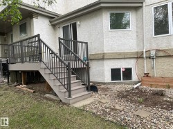 Multi-level outdoor deck featuring a gray finish and dark-toned metal railings - 