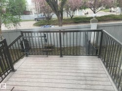 Composite deck with dark metal railings and gate - 