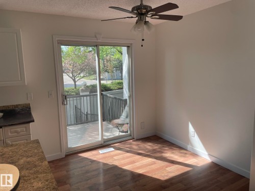 Sliding glass door leading to an outdoor deck with metal railing - 2 1295 Carter Crest Road, Edmonton, AB - Indoor Photo Showing Other Room