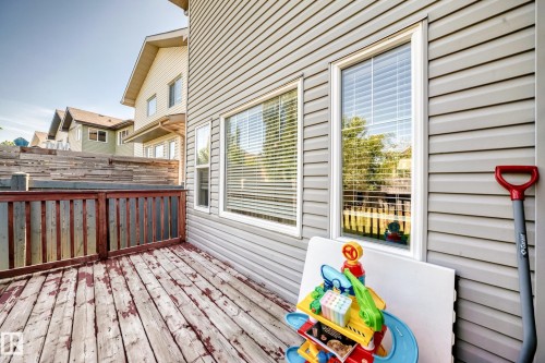 Wood-finish deck with a perimeter railing and a privacy wall - 3433 Goodridge Link Link, Edmonton, AB 