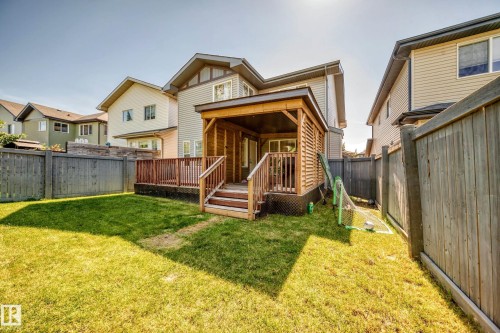 Expansive backyard featuring a covered patio with wood siding and a wood deck - 3433 Goodridge Link Link, Edmonton, AB 