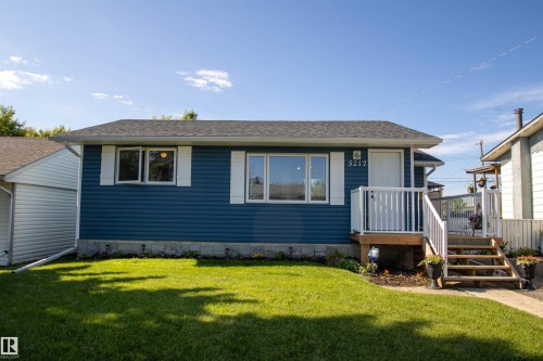 Blue horizontal siding with white window trim - 5217 47 Ave, St. Paul Town, AB 