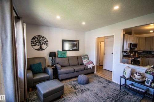 Living area featuring recessed lighting and wood-finish flooring - 5217 47 Ave, St. Paul Town, AB 