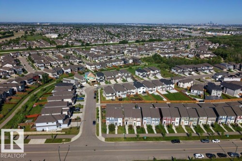 Aerial perspective of a developed residential area featuring a variety of housing styles, including detached homes and rows of townhomes - 2116 Maple Road, Edmonton, AB 
