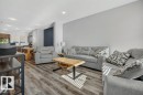 Open-concept living area featuring wood-finish flooring and recessed lighting - 2116 Maple Road, Edmonton, AB 