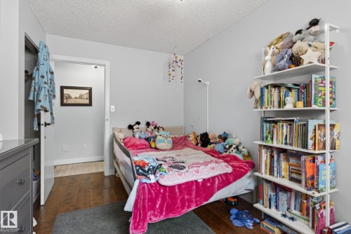 Room featuring wood-finish flooring, light gray wall paint, and a textured ceiling - 9821 153 Street, Edmonton, AB - Indoor Photo Showing Bedroom
