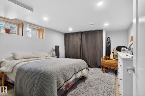 Recessed lighting illuminates this room featuring light gray walls, wood-finish flooring, and two high-set windows - 9821 153 Street, Edmonton, AB - Indoor