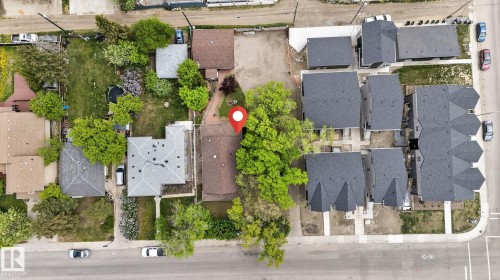 Aerial perspective showcasing a residential property with a dark shingle roof and surrounding mature trees - 9821 153 Street, Edmonton, AB - Outdoor With View