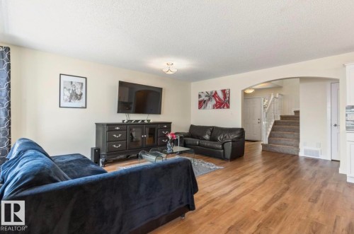 Open-concept living space with wood-finish flooring - 1007 Macewan Cl, Edmonton, AB 