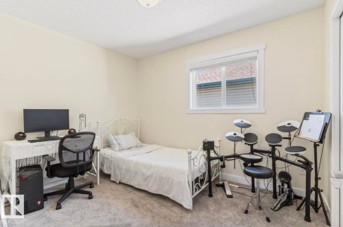 Interior room with neutral wall tones and textured carpeting - 1007 Macewan Cl, Edmonton, AB 