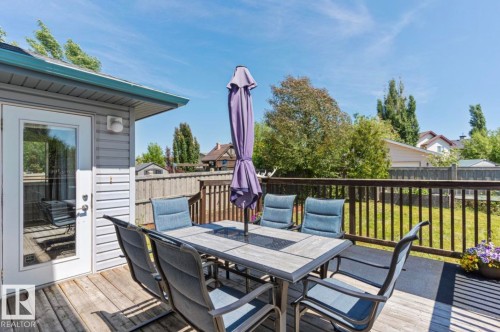 Expansive wood-finish deck with a dark wood-stained railing - 1007 Macewan Cl, Edmonton, AB 