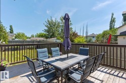 Expansive wooden deck with a complete railing system overlooking a grassy yard - 