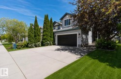 Contemporary two-story residence with light gray siding and dark trim - 