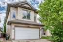 Two-story residence featuring light-toned horizontal siding with dark trim accents - 1549 37C Avenue, Edmonton, AB 
