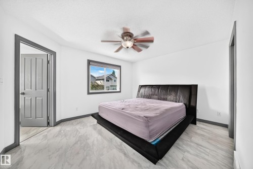 Bright room featuring light-toned flooring, a window with exterior views, and a ceiling fan - 1549 37C Avenue, Edmonton, AB 