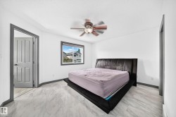 Bright room featuring light-toned flooring, a window with exterior views, and a ceiling fan - 