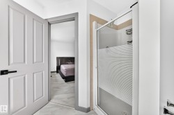 Modern shower enclosure with frosted glass panel and integrated shelving - 