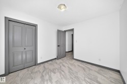 Room featuring light-toned flooring, white walls, and a ceiling light fixture - 
