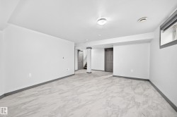 Spacious room featuring light-toned large format tile flooring and a neutral color palette - 