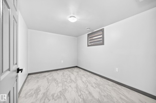 Neutral gray wall paint with contrasting baseboards - 1549 37C Avenue, Edmonton, AB 