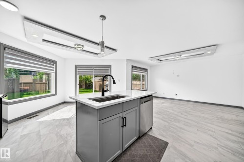 Kitchen island with a built-in sink and dishwasher - 1549 37C Avenue, Edmonton, AB 