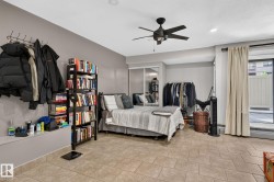 Spacious room featuring neutral-toned tile flooring, recessed lighting, and a ceiling fan - 