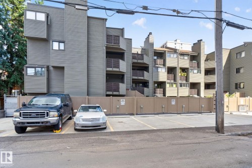 Multi-story building featuring horizontal siding, multiple balconies, and a private parking area - G14 10148 118 Street Nw, Edmonton, AB 