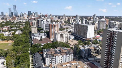 Expansive urban landscape featuring a dense collection of buildings and abundant mature tree canopy - G14 10148 118 Street Nw, Edmonton, AB 