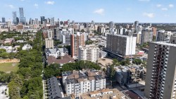 Expansive urban landscape featuring a dense collection of buildings and abundant mature tree canopy - 