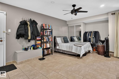 Spacious room featuring large format tile flooring, a built-in bench, recessed lighting, and a ceiling fan - G14 10148 118 Street Nw, Edmonton, AB 