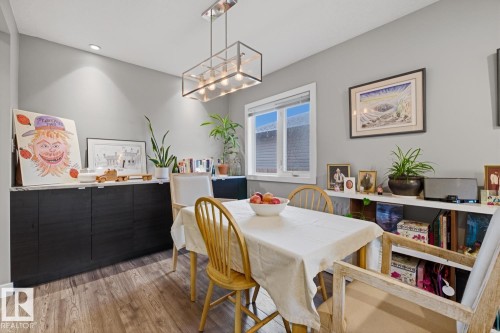 Dining area with additional cabinet storage space, quartz countertop, and a modern chandelier - 10328 73 Street, Edmonton, AB 