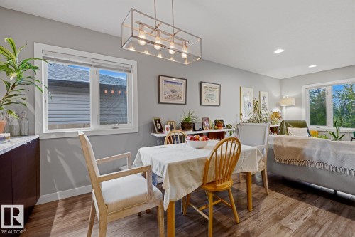 Dining area with additional cabinet storage space, quartz countertop, and a modern chandelier - 10328 73 Street, Edmonton, AB 