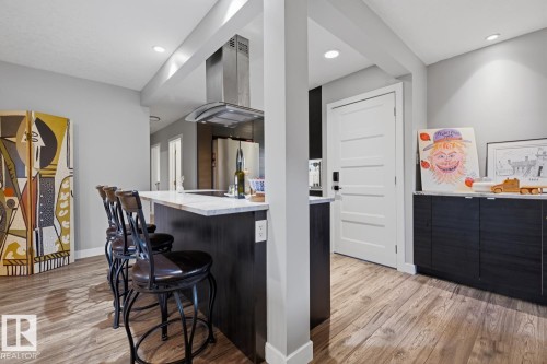 Open-concept kitchen featuring an island with room for seating - 10328 73 Street, Edmonton, AB 