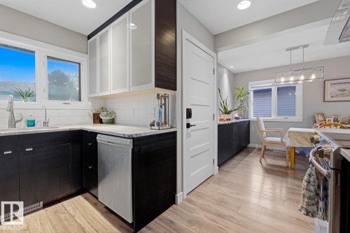 Kitchen featuring stainless steel appliances and quartz countertop - 10328 73 Street, Edmonton, AB 