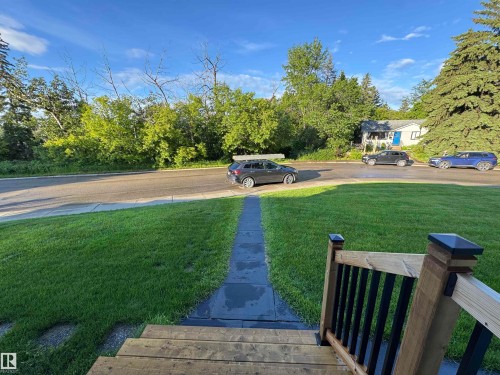 Boasting a lush front lawn, the property is directly across from Fulton Ravine, providing gorgeous year-round views from both inside and out of the home - 10328 73 Street, Edmonton, AB 