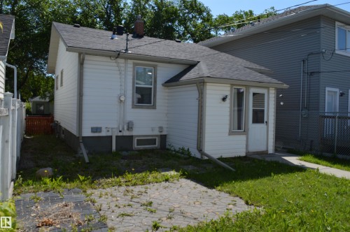 White sided exterior with dark shingle roofing - 11920 78 Street, Edmonton, AB 
